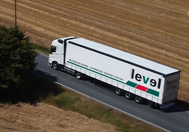 Kamión firmy Jiří Žabka – LEVEL ide po ceste medzi poľami